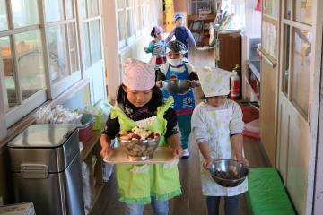 切った食材を給食室に運ぶ子ども達